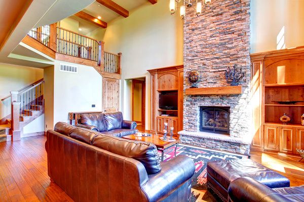 Family room with vaulted ceiling and stacked stone fireplace