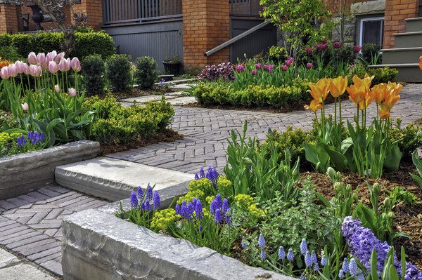 Flower bed with stone retaining walls and a paver patio