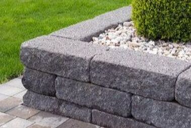 Grey stone landscape retaining wall on patio
