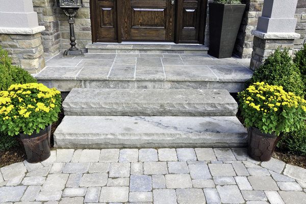Stone paver entrance way with stone steps and patio